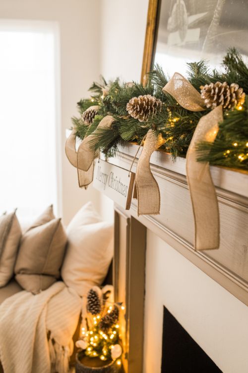 Living room decorated with elegant yet inexpensive Christmas decor, featuring burlap ribbons, gold-painted pinecones, faux greenery, soft throws, and subtle metallic accents, creating a cozy and chic holiday atmosphere.