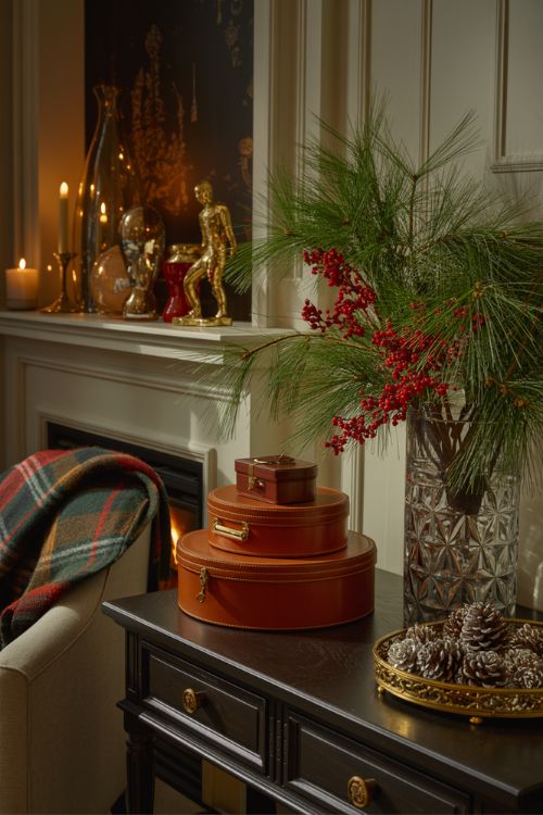 Ralph Lauren holiday home accessories including leather trinket boxes, crystal vases, decorative trays, and elegant festive decor on shelves and tables.