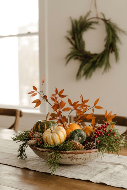 Dining room decor transition showing fall foliage with pumpkins replaced by pinecones, cranberries, and winter greenery for a cozy seasonal update.