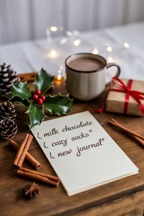 Thoughtful Christmas List on Paper in a Cozy Holiday Workspace