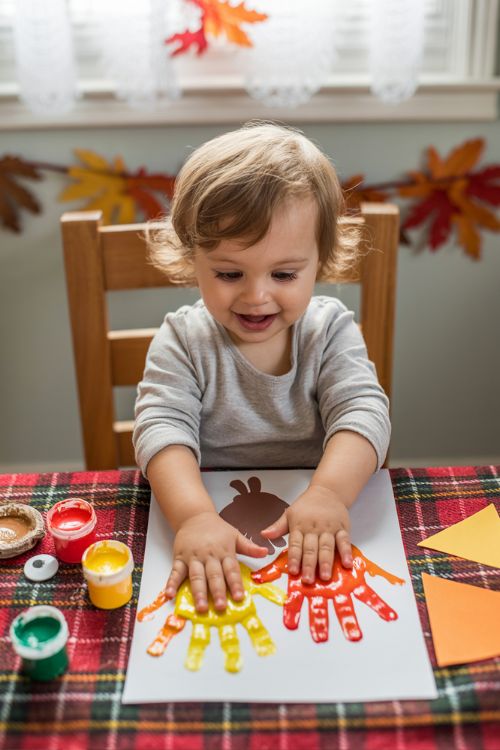 Toddler Creating Handprint Turkey Craft for Thanksgiving