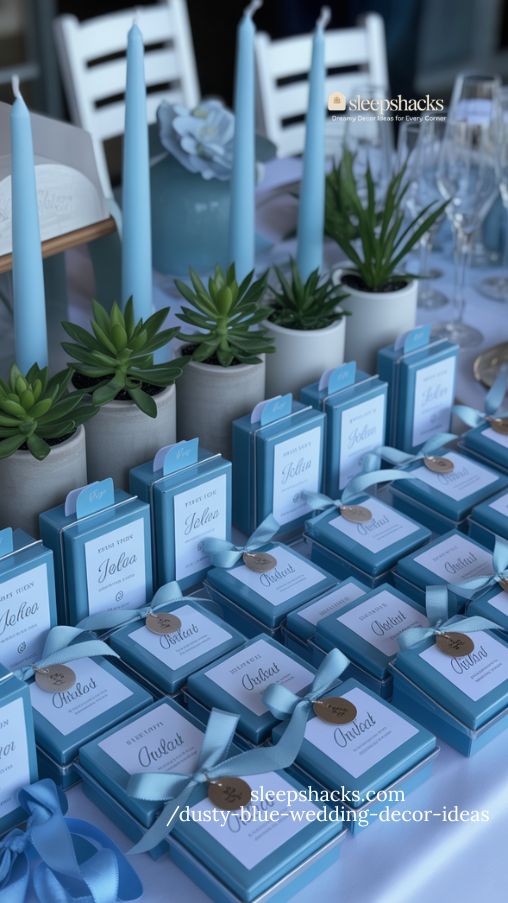 dusty blue wedding favors with ribbons candles and personalized details