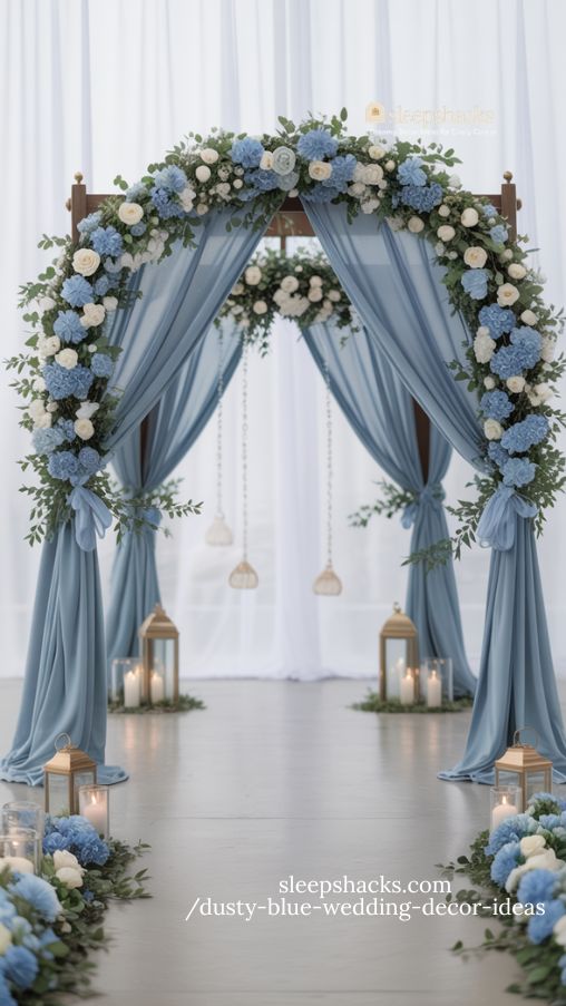 elegant dusty blue wedding arch with romantic florals and greenery