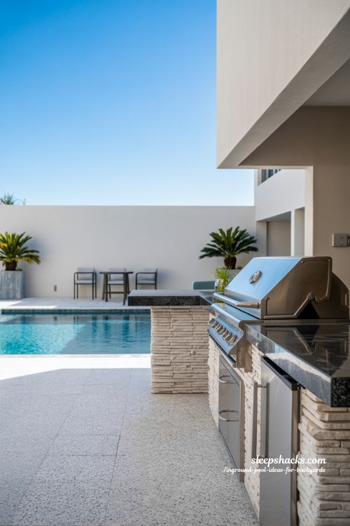 Modern Backyard Inground Pool with Integrated Outdoor Kitchen and Dining Island