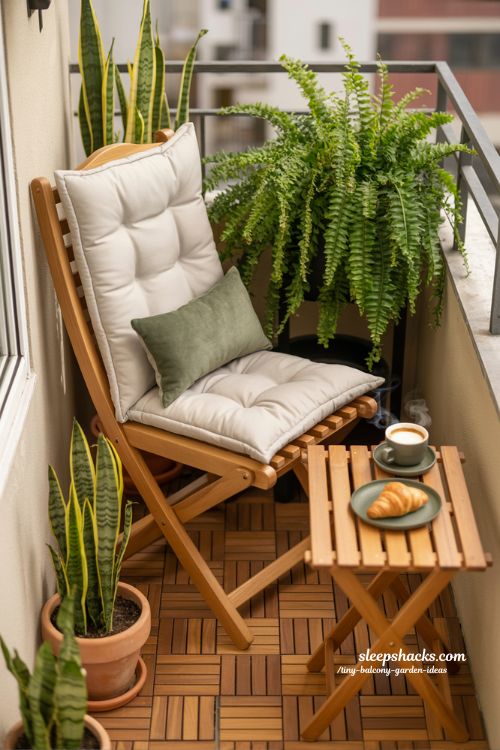 Cozy Foldable Seating Nook in a Lush Tiny Balcony Garden