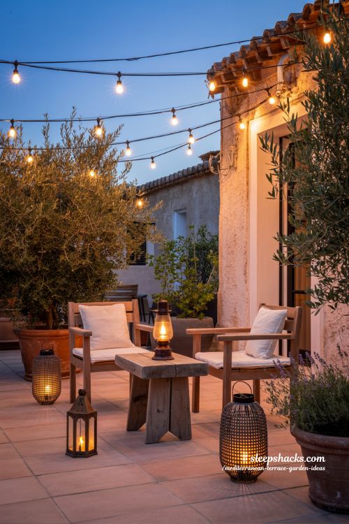 Cozy Mediterranean Terrace Evening with Layered Warm String Lights and Lanterns