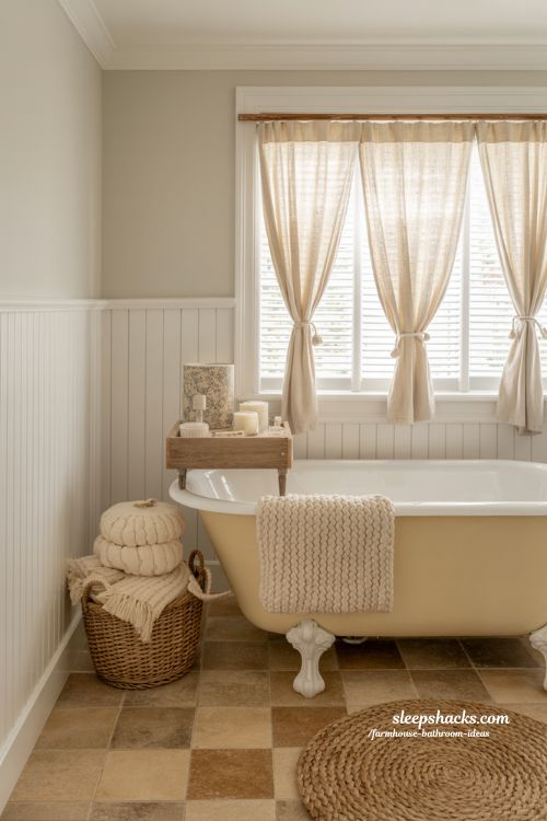 Earthy Farmhouse Bathroom with Sage Green Walls, Clawfoot Tub, and Reclaimed Wood Vanity