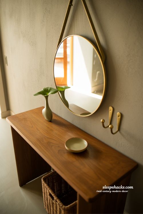 Mid-century modern entryway with walnut console mirror and minimal welcoming decor
