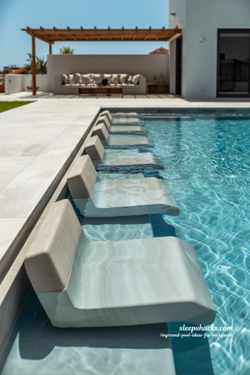 Modern Inground Pool with Integrated Underwater Bench Seating and Sun Shelf