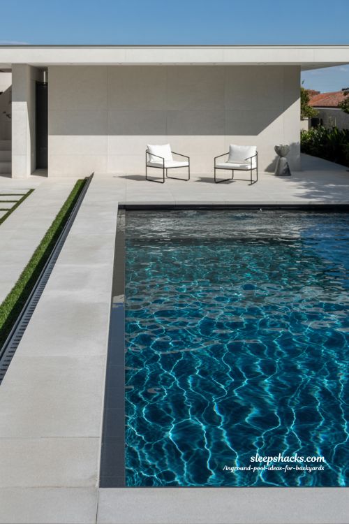 Sleek Modern Rectangular Inground Pool with Concrete Decking and Minimalist Lounge Area
