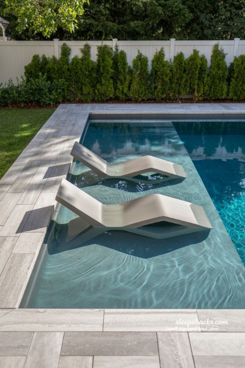 Small Rectangular Inground Pool with White Tanning Ledge and Dual In-Water Sun Loungers