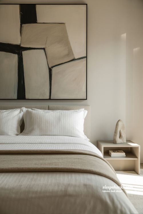 Statement art above bed decor that creates a bold and elegant focal point