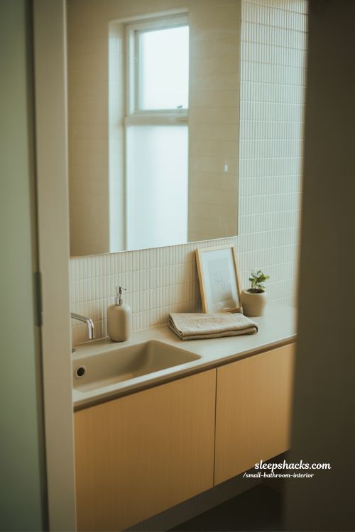 Subtle small bathroom interior decor ideas minimalist Japandi design soft towel plant framed art calm neutral aesthetic