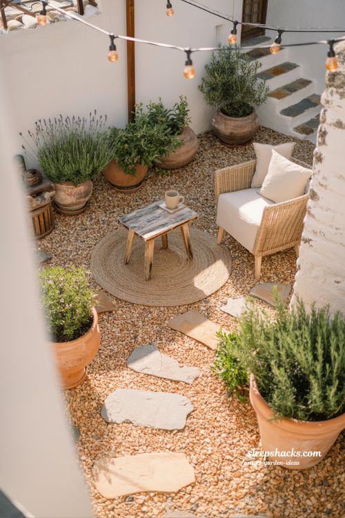 Sunny Cozy Courtyard with Gravel Patio, String Lights, and Terracotta Pots