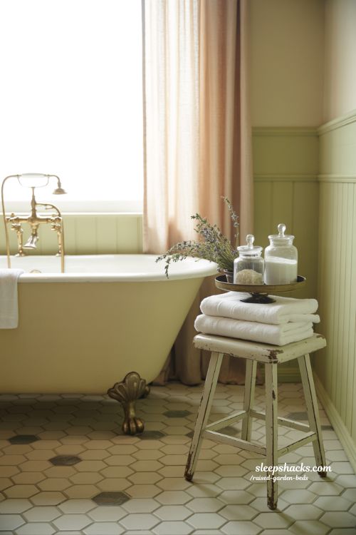 Vintage bathroom decor featuring antique tub and soft warm colors in sharp focus