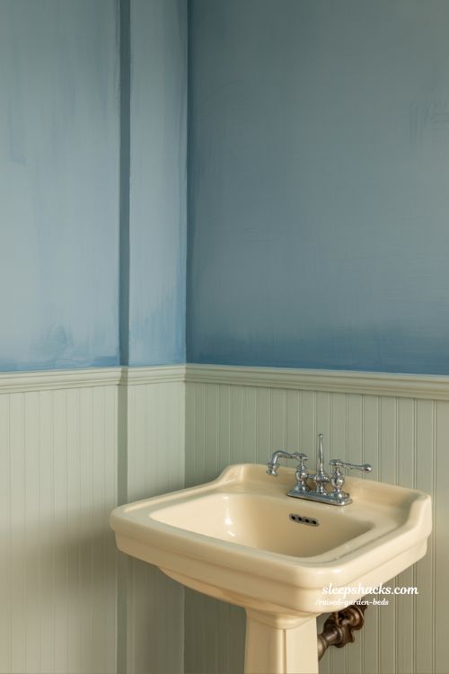 Vintage bathroom decor with muted blue and cream color palette in sharp focus