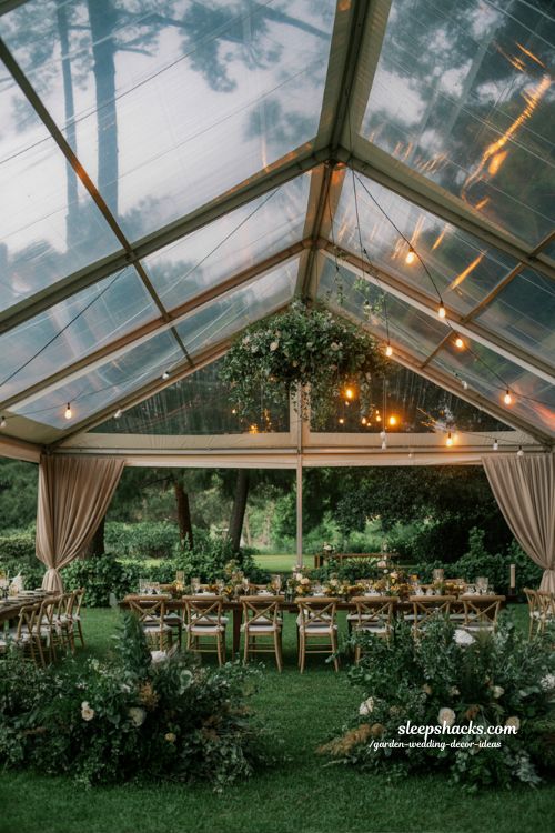 clear tent wedding reception ideas with warm lights and elegant minimal garden decor for weather proof outdoor celebration 