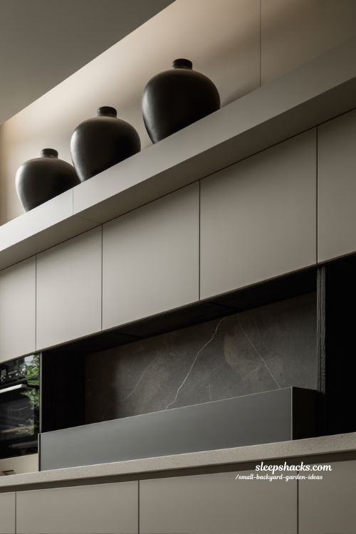 modern above cabinet decor ideas with clean lines and minimalist black vase styling in a luxury contemporary kitchen