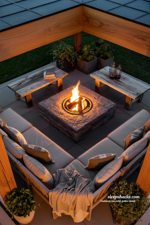 outdoor covered patio with fire pit seating area warm evening glow and cozy modern rustic gathering space
