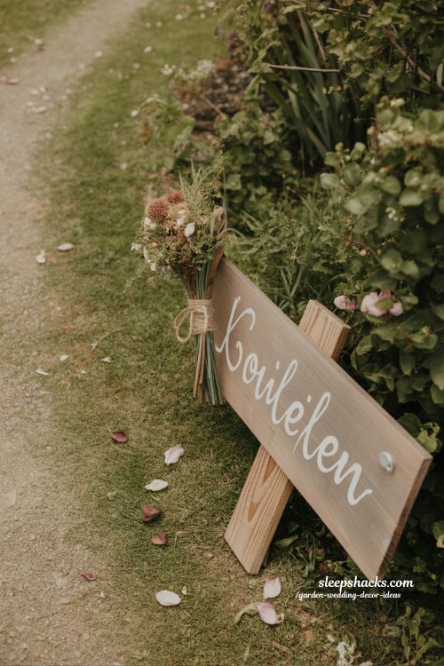 rustic wooden wedding signage ideas with handwritten style and natural garden charm 