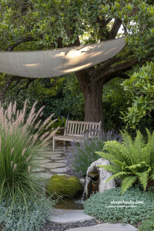 shaded backyard garden corner with bench water feature and swaying grasses for relaxing summer mood