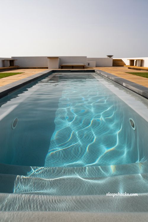 Auto cover fiberglass pool system with modern rectangular backyard design emphasizing safety, cleanliness, and low-maintenance luxury living