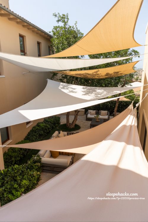 Backyard privacy ideas with angled shade sails for overhead view blocking outdoor patio design