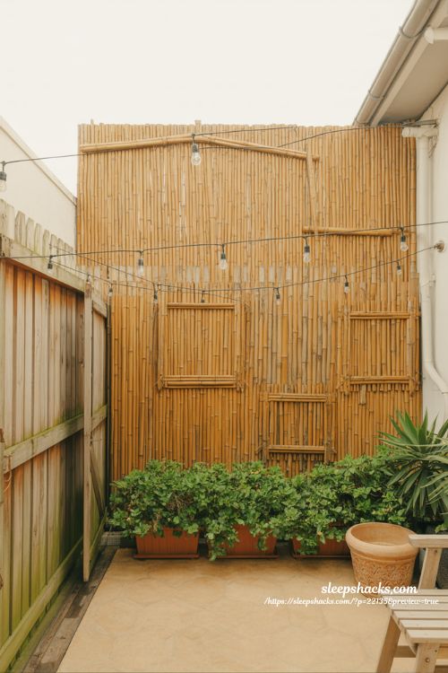 Backyard privacy ideas with inexpensive bamboo panels for quick renter friendly fence cover design