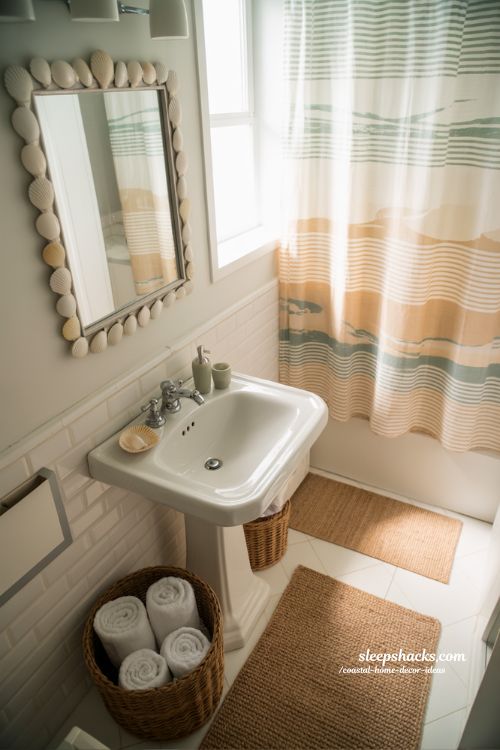 Coastal bathroom decor ideas with shell mirror and woven baskets for a spa like beach inspired bathroom 