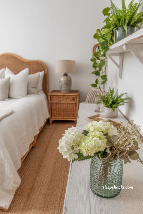 Coastal grandma bedroom with fresh white hydrangeas and soft natural greenery accents