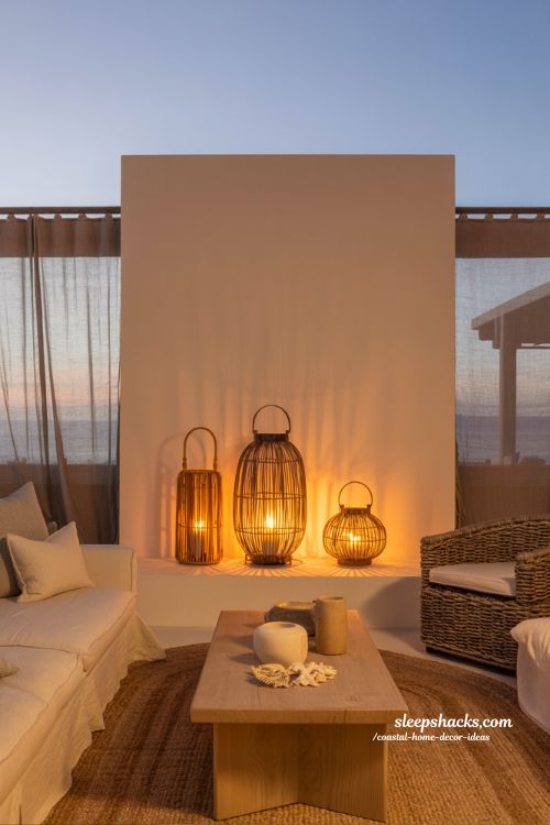 Coastal home decor ideas with rattan lantern lighting and candle holders creating a warm beach inspired evening interior 