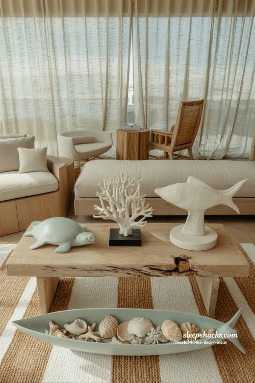 Coastal home decor ideas with sculptural aquatic figurines and shell decor in a calm beach inspired living room 