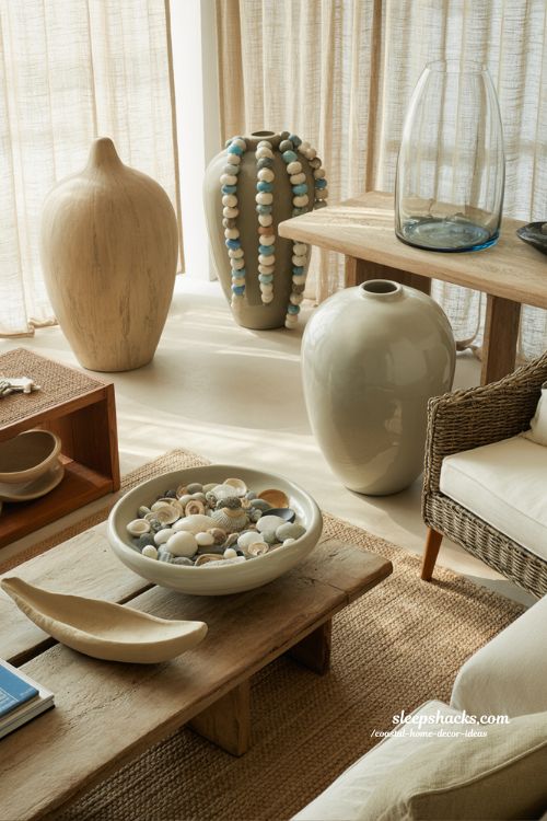 Coastal home decor ideas with sea glass vases and shell bowls styled in a calm beach inspired living room
