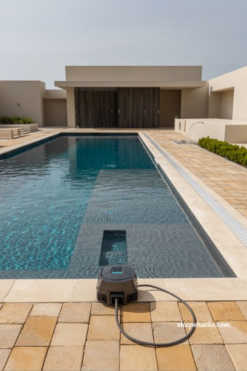 Fiberglass pool with robotic cleaner and smart automation equipment modern backyard low maintenance pool system and clean minimalist outdoor design