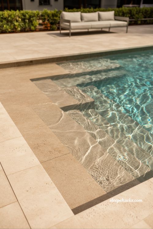 Fiberglass pool with wading area beach entry family friendly backyard pool design with shallow slope and modern safe outdoor living space