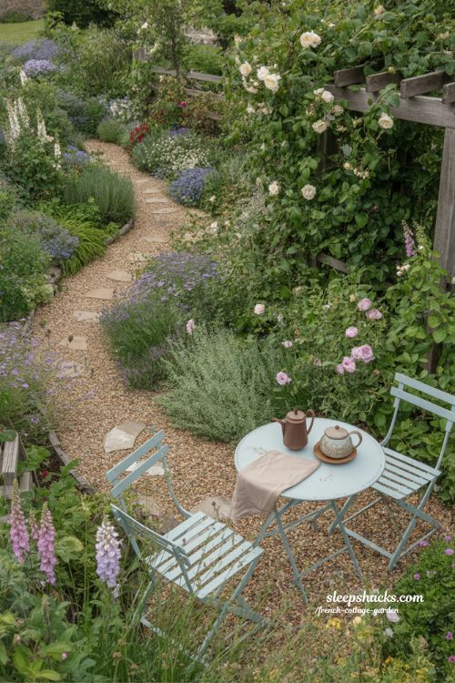 French cottage garden layout ideas with winding gravel paths spilling flowers and cozy resting spots for a natural effortless look