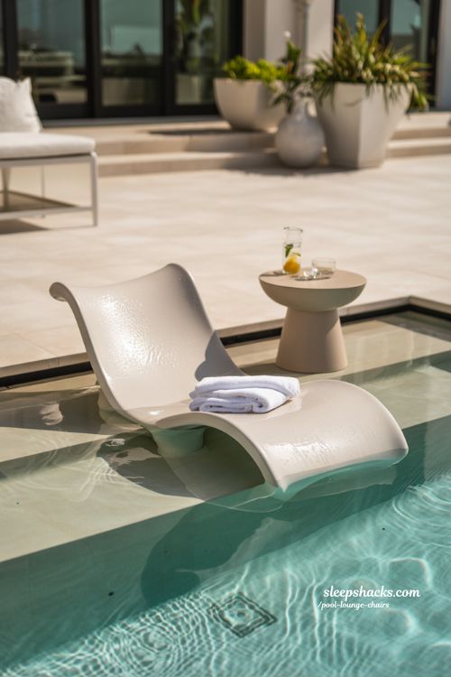 Modern white in-pool tanning ledge lounger in a contemporary luxury backyard pool 