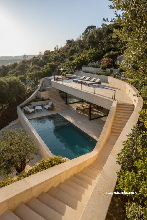 Multi-zone backyard pool garden with upper sun deck and lower terrace modern hillside landscape design with tiered retaining walls and layered lighting