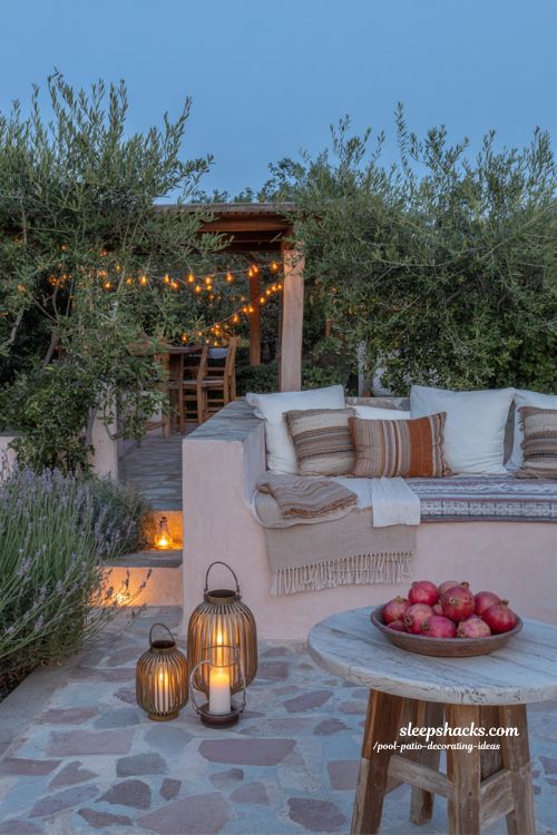 Pool patio decorating ideas with layered lighting, string lights, lanterns, and deep-blue twilight mood