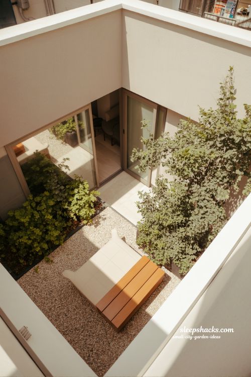 Small city garden ideas using natural light, reflections and bright surfaces to transform shaded urban outdoor spaces