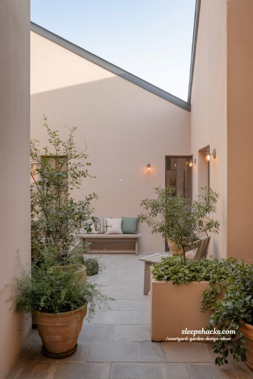 Small courtyard garden design showing plants seating lighting and structure balance