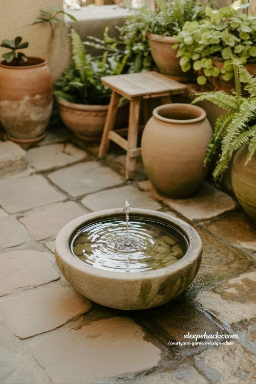 Small courtyard garden with simple water feature for calm relaxing atmosphere