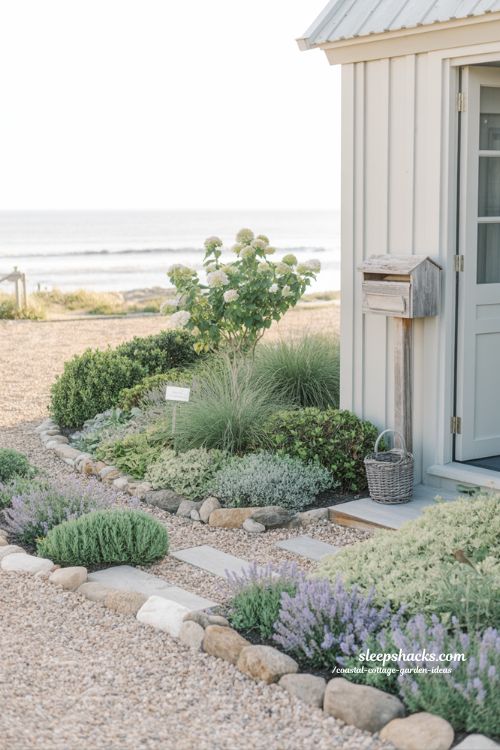 Small front yard coastal cottage garden ideas with layered lavender borders and gravel path