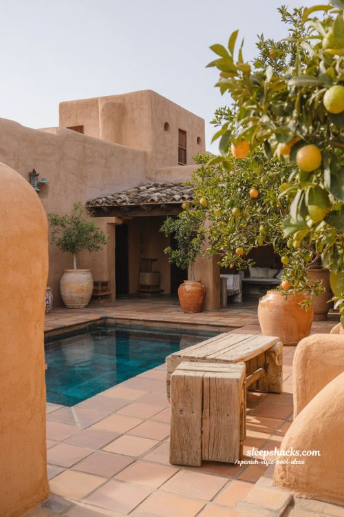 Spanish hacienda pool ideas with red clay roof accents and rustic courtyard design
