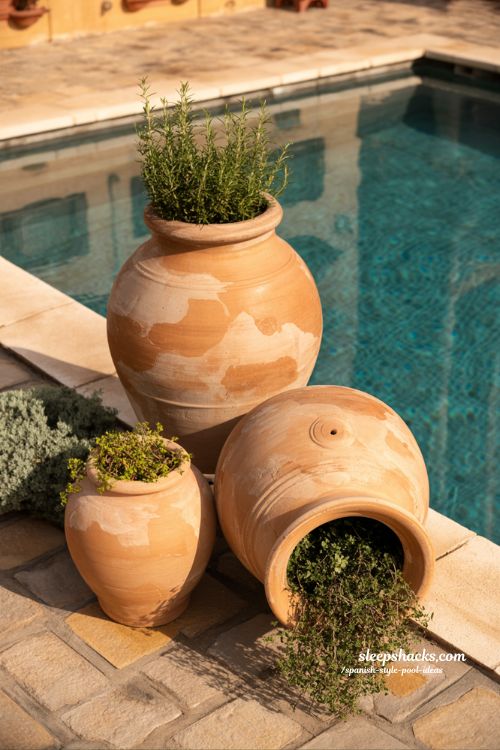 Spanish style pool ideas with decorative terracotta urns and mediterranean courtyard design