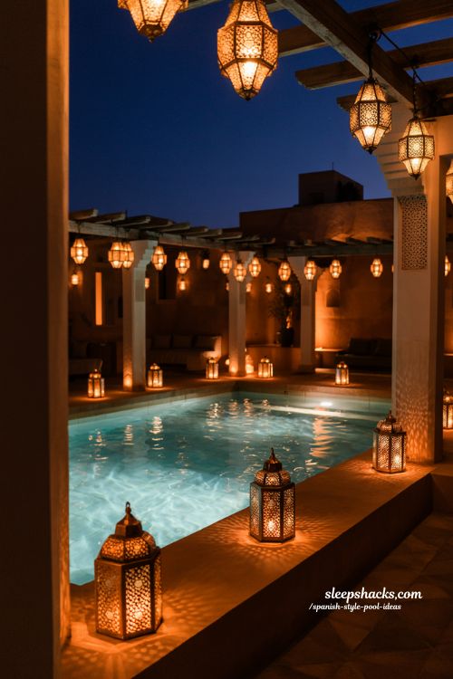 Spanish style pool ideas with moroccan lantern lighting and romantic night courtyard design