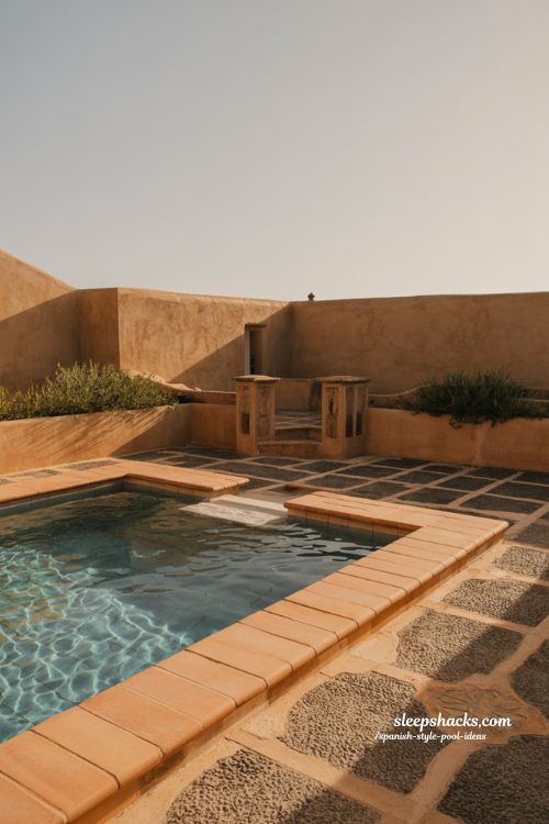 Spanish style pool ideas with terracotta coping and stone courtyard design