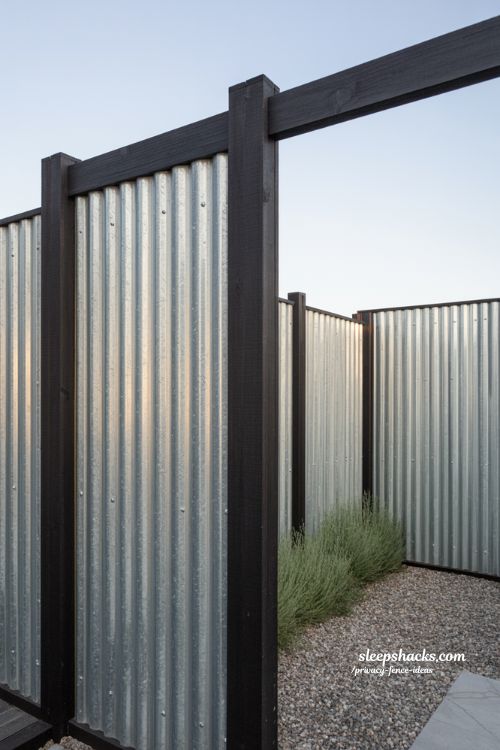 corrugated metal privacy fence ideas with wood posts for a modern industrial backyard and patio divider