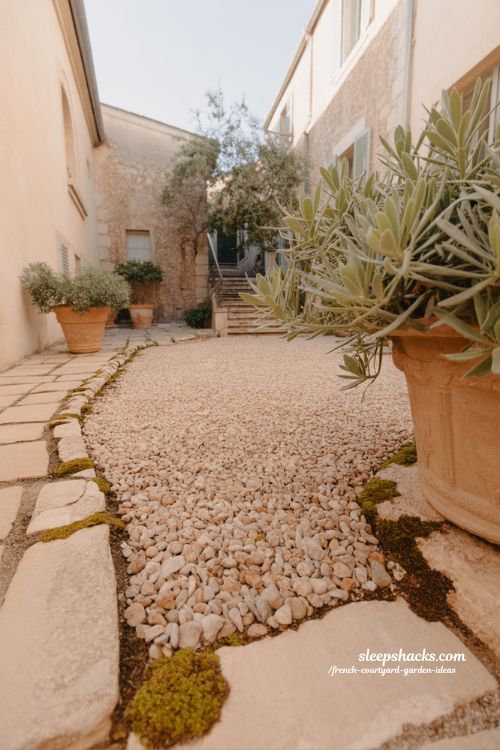 french courtyard garden gravel pathways with natural flow rustic stone textures and calm garden movement