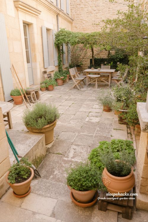 french courtyard garden outdoor living space with effortless natural design and lived in timeless atmosphere